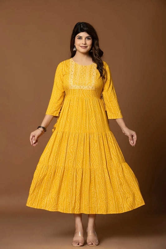 mustard yellow bandhani print flared dress with embroidered yoke festive wear